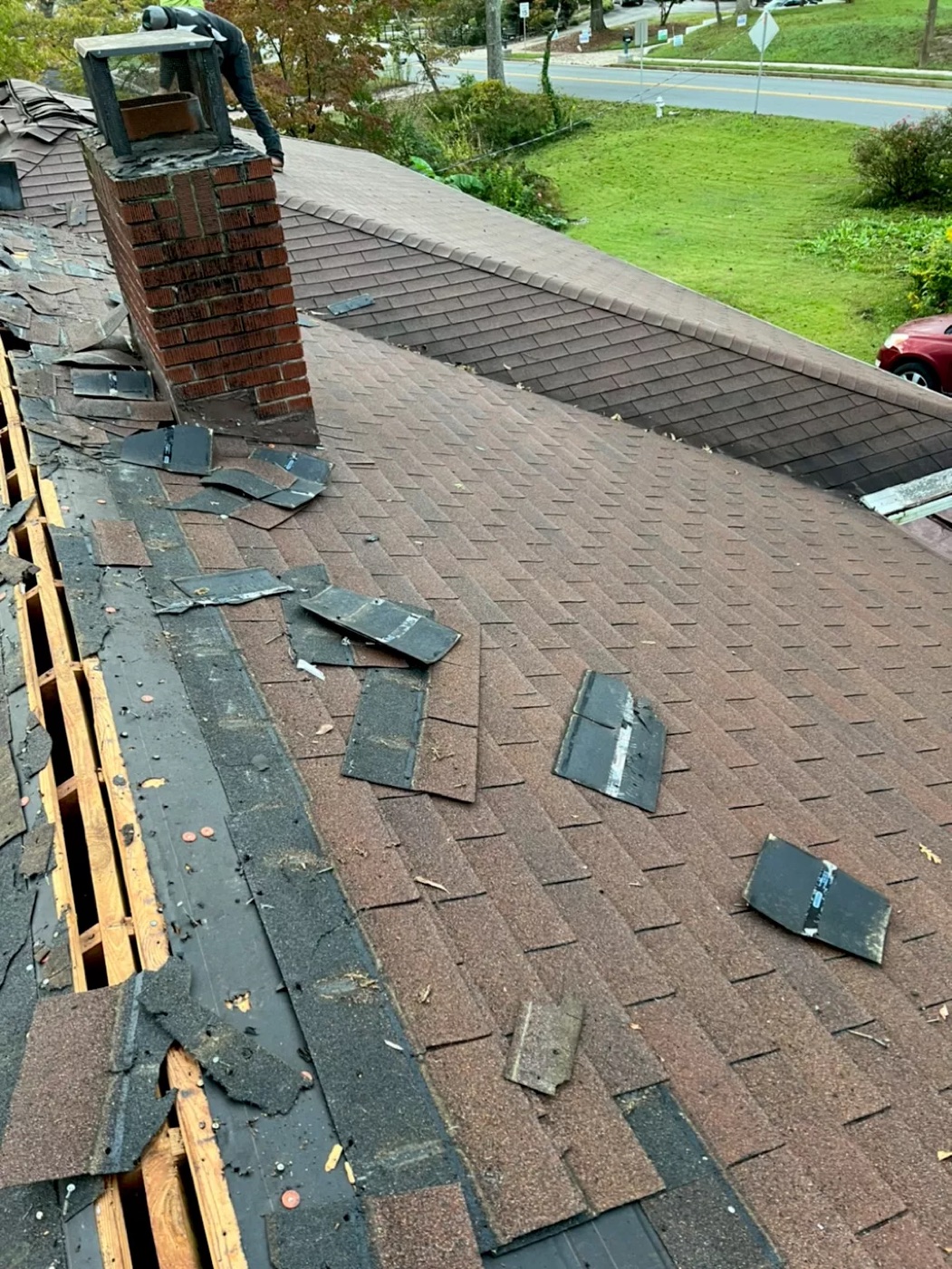 Roof mid-replacement with old shingles being removed